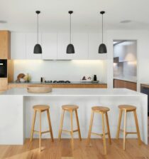 brown wooden seat beside white wooden table